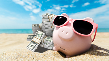 piggy bank with money on the beach summer time