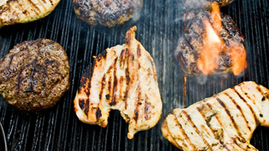 beef and chicken on a grill