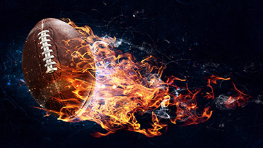 football flying through air with flames coming off of it